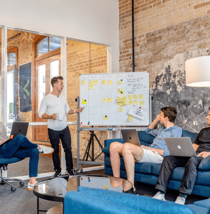 Team discussing project on whiteboard